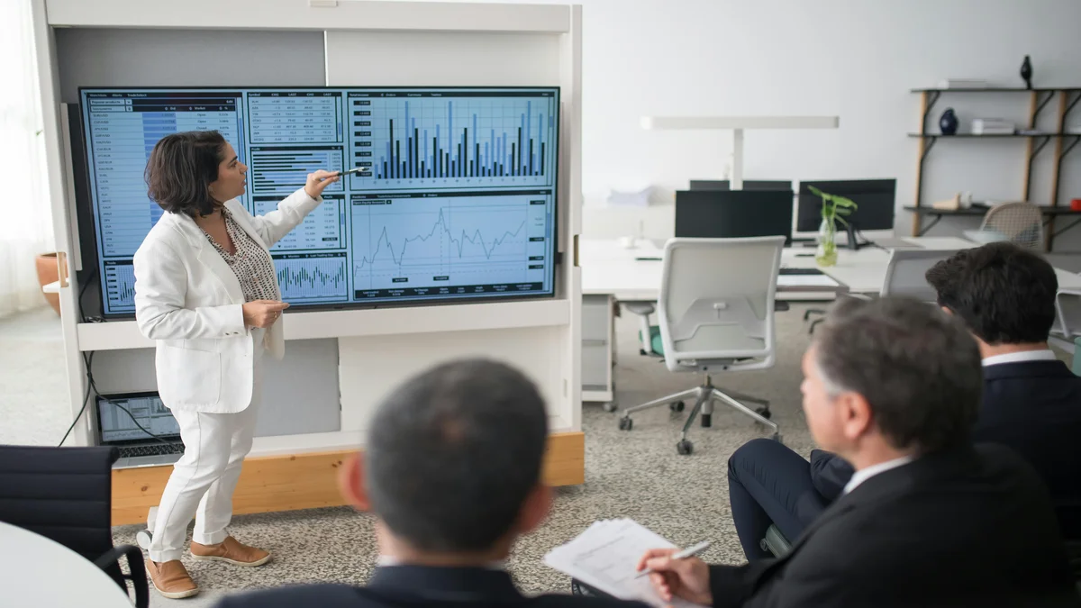 Profissional apresentando analise de dados e estrategia digital para equipe em escritorio, representando uso de IA em campanha eleitoral